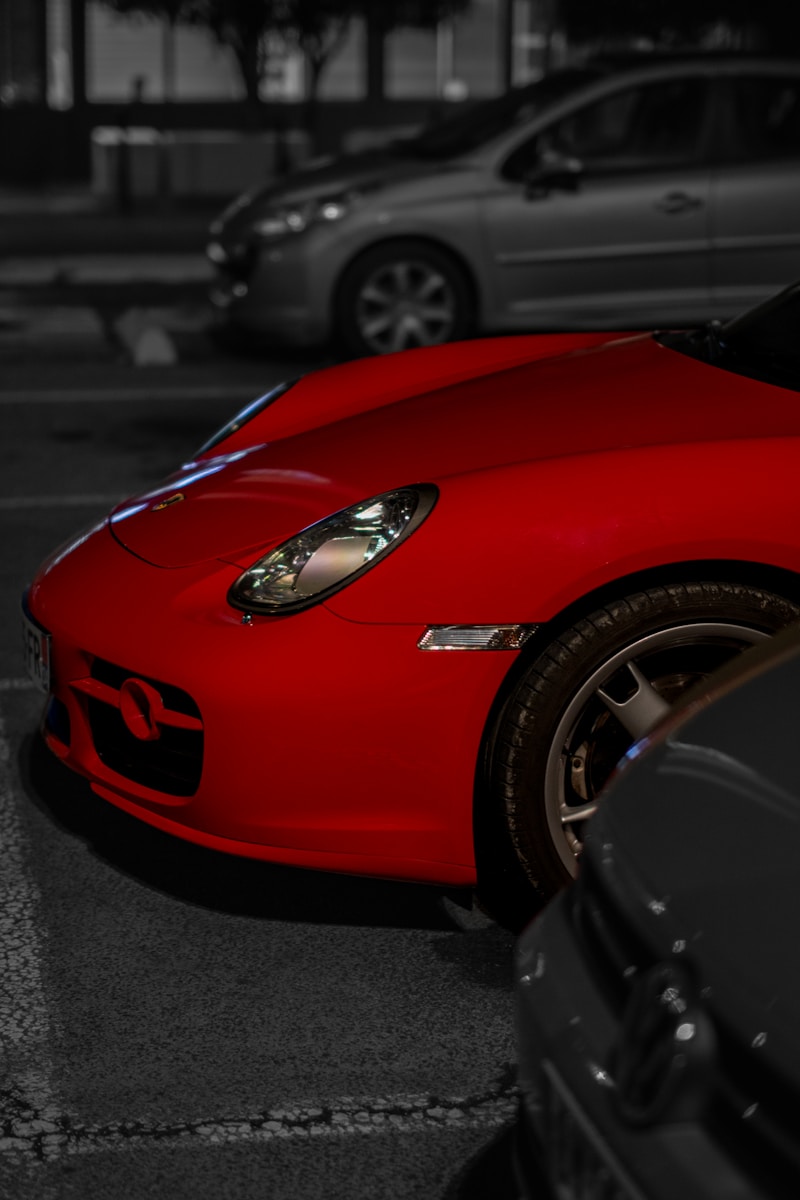 A red sports car parked in a parking lot